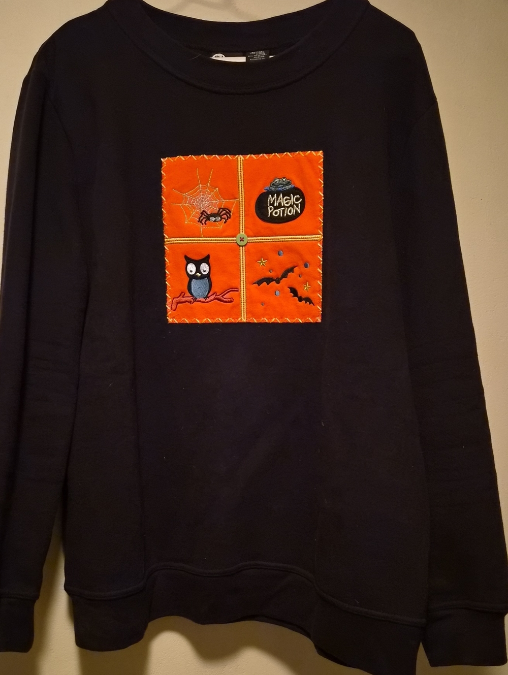 Holiday Editions Black Crewneck Sweatshirt with Orange Halloween Patch